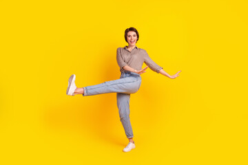 Full size photo of young cheerful girl have fun dancing party clubber isolated over yellow color background