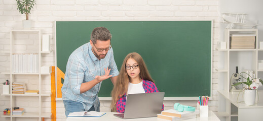 childhood education. concentrated pupil and tutor with laptop. father and teen girl study.