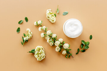 White moisturizing cream cosmetic for spa treatment with blossoms flowers