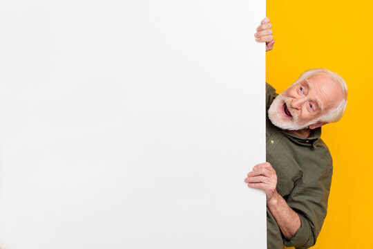 Photo of cool aged white hairdo man look promo wear khaki outfit isolated on yellow color background