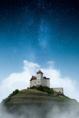 A castle on a hill with stars of the milky way in the sky. A fairy tale castle from a children's...