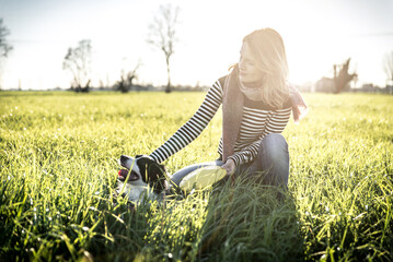 Beautiful woman with her loyal border collie dog at the park