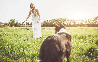 Beautiful woman with her loyal border collie dog at the park