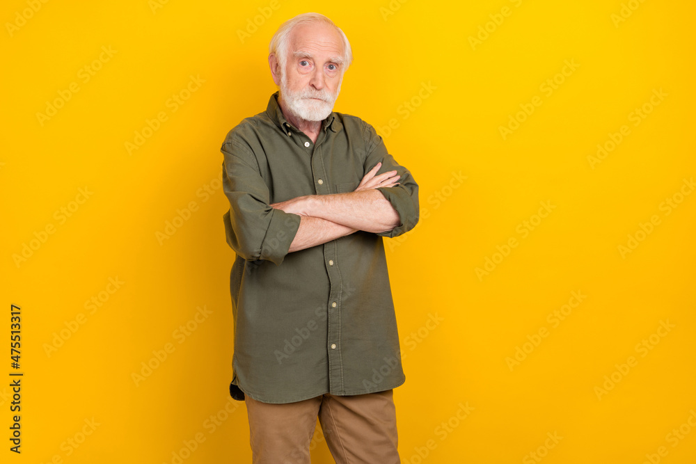 Sticker Photo of calm focused aged man crossed arms look camera isolated on bright yellow color background