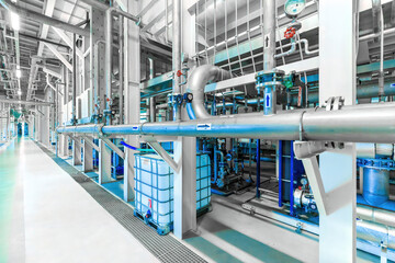 Photo of pipes and tanks. Chemistry and medicine production. Pharmaceutical factory. Interior of a high-tech factory, modern production. Blue tone