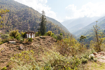 Fototapeta na wymiar Farmer house in the local style in the mountains in Bhutan, Asia