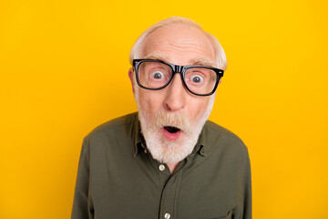Photo of astonished aged person open mouth look speechless camera isolated on yellow color...
