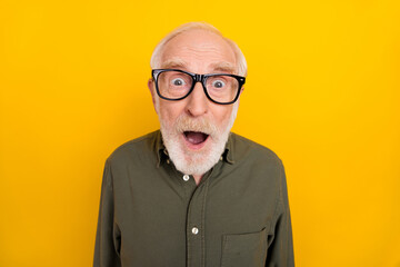 Portrait of impressed aged man open mouth staring camera cant believe isolated on yellow color...