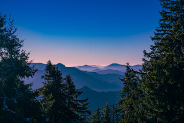 View from the mountains to the hills after sunset. Clear sky.