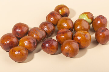 Jujube or Monkey apple fruit isolated on yellow background.