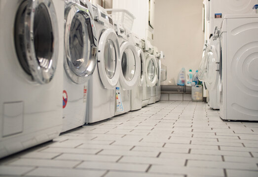 Laundry Room Of An Apartment House In The Basement With Some Washers In A Row