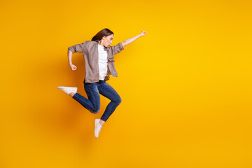 Fototapeta na wymiar Full size profile side photo of young lady jump fly look empty space help superhero isolated over yellow color background