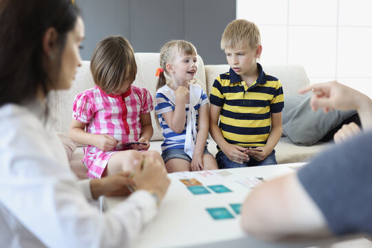 Children decide who goes next, playing card game with parents at home