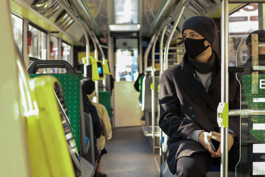 Multi-age European man in a face mask traveling in public transport by bus