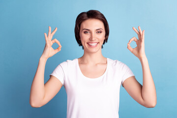 Photo of young cheerful lady show fingers fine recommend okey symbol isolated over blue color background