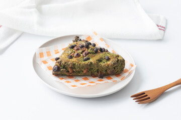 green tea scone in triangle shaped on plate.