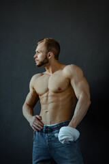 Fototapeta premium young man, brutal appearance, with a beautiful torso, bodybuilder, in the studio on a black background, BW photo