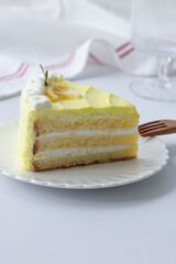A piece of lemon cream cake on a plate.
