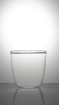 Water sways in a transparent faceted glass.