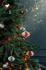 Obraz na płótnie Canvas Christmas tree decorated with handmade eco paper ball, closeup view.