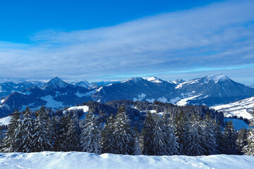 Beautiful winter landscape in the Swiss mountains. Panoramic view over the snow covered landscape.