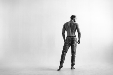 young man, brutal appearance, with a beautiful torso, bodybuilder, in the studio on a white background, BW photo