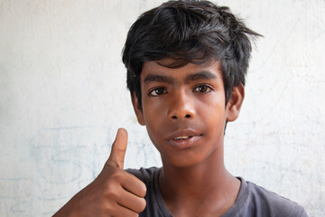 Portrait Of Rural Boy Gesturing Thumbs Up Sign