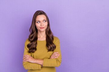Photo of successful minded lady crossed hands look interested empty space isolated on violet color background
