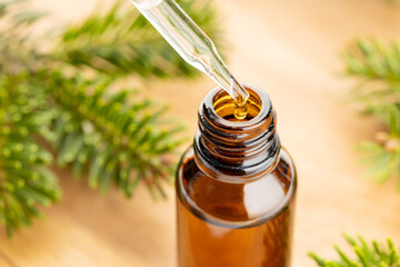 Fir essential oil in bottle still life. Herbal remedies