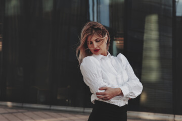 Portrait stylish businesswoman outdoors in business district