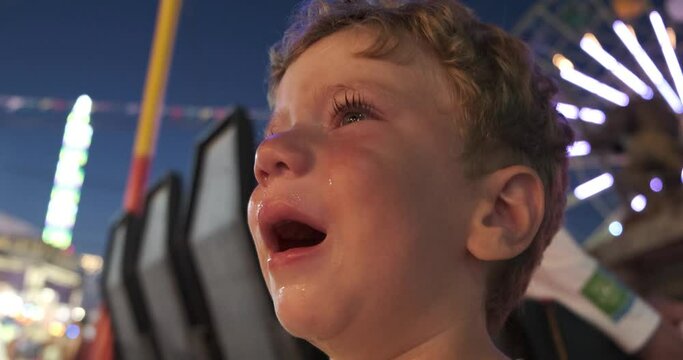little boy crying in the amusement park