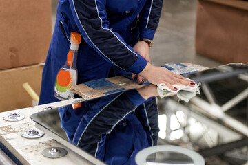 A worker assembles furniture at a factory. Industrial production of furniture.