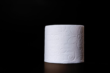 Top view of unrolled toilet paper at black background
