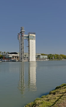 Schindler Tower Reflecting In The Water Of Guadalquivir River In Seville. This Observation Tower Was Built On The Isla De La Cartuja As Part Of The Exposition Of Seville 1992 