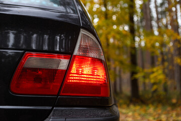 Rear end close up BMW E46 red car lights.