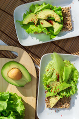 Healthy Homemade Avocado Toast with Salt lettuce leaves. Whole food concept. Vertical photo
