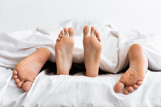 Married Couple Having Sex Lying Under Blanket In Bed Indoor