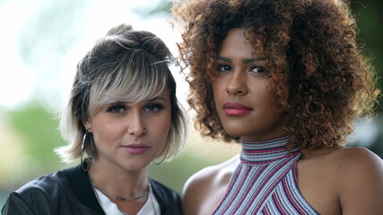 Two diverse women portrait faces looking at camera