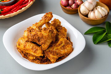 Rendang Ayam or Chicken Rendang,  is an Indonesian food from West Sumatra in Indonesia. 
Chicken Rendang served on plate and isolated gray background.