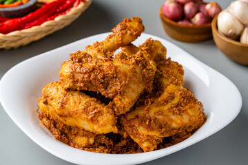 Rendang Ayam or Chicken Rendang,  is an Indonesian food from West Sumatra in Indonesia. 
Chicken Rendang served on plate and isolated gray background.