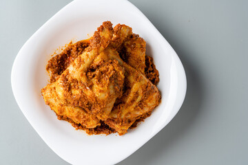 Rendang Ayam or Chicken Rendang,  is an Indonesian food from West Sumatra in Indonesia. 
Chicken Rendang served on plate and isolated gray background.