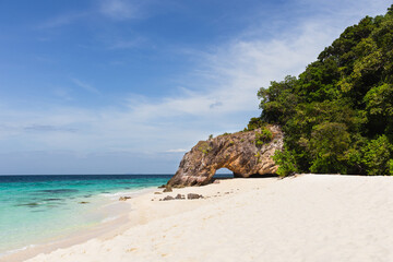 Natural stone arch and white beach at Ko Khai near Tarutao national park Satun Thailand.