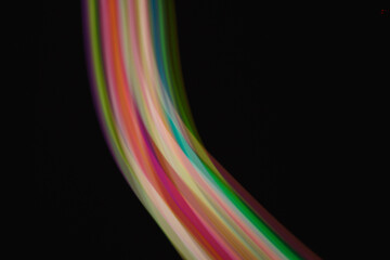 Colored lines of light on a black background.