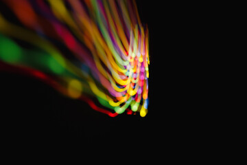 Colored lines of light on a black background.