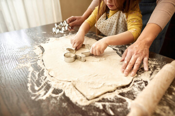 Obscure face of girl making cookies with grandma