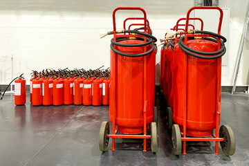 A lot of fire extinguishers. Protection and security in case of fire. Industrial background. - 475532563