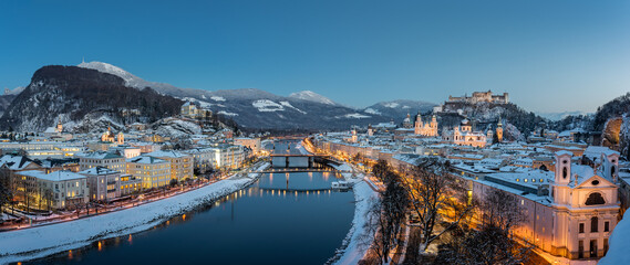 Panorama view of the snow-covered city of Salzburg in the evening, Austria