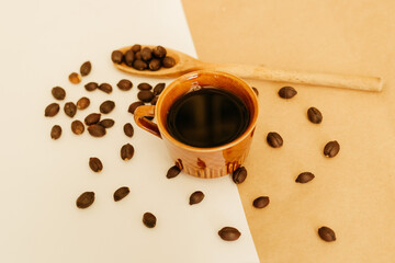 black coffee cup with beans in the minimalist background