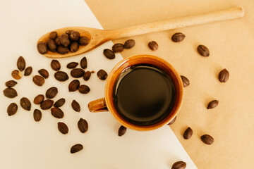 black coffee cup with beans in the minimalist background