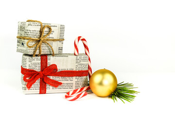 Gifts wrapped in old newspaper on white background